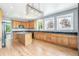 Bright kitchen boasts light wood cabinetry, black granite counters, and an island at 5789 S Jay St, Littleton, CO 80123