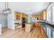 Open kitchen featuring wood cabinets, granite counters, center island, and modern appliances at 5789 S Jay St, Littleton, CO 80123