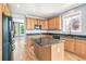 Spacious kitchen featuring an island, modern appliances, and hardwood flooring at 5789 S Jay St, Littleton, CO 80123