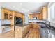 Bright kitchen featuring wood cabinets, granite counters, center island, and stainless appliances at 5789 S Jay St, Littleton, CO 80123