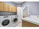 Laundry room with full-size washer and dryer and utility sink at 5789 S Jay St, Littleton, CO 80123