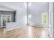 Open-concept living room with hardwood floors, large windows, and a view of the outdoors at 5789 S Jay St, Littleton, CO 80123