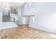 Spacious living room with soaring ceilings, hardwood floors, and large windows allowing ample natural light at 5789 S Jay St, Littleton, CO 80123