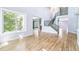 Bright living room with hardwood floors, staircase access, and views into other rooms at 5789 S Jay St, Littleton, CO 80123
