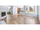 Open concept living room featuring a fireplace, hardwood floors, and access to kitchen at 5789 S Jay St, Littleton, CO 80123
