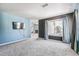Open-concept living room with plush carpeting and a mounted TV at 5789 S Jay St, Littleton, CO 80123