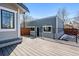 Backyard featuring a deck, black iron fencing, and a detached garage at 1401 S Clarkson St, Denver, CO 80210