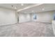 Spacious basement with neutral carpet, recessed lighting, and bright window at 1401 S Clarkson St, Denver, CO 80210