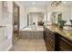 Well-lit bathroom with a soaking tub, glass shower, and granite vanity at 1401 S Clarkson St, Denver, CO 80210