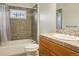 Cozy bathroom with a shower and bathtub, tiled walls, and a vanity sink at 1401 S Clarkson St, Denver, CO 80210