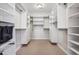 Walk-in closet featuring custom shelving, drawers, and ample storage space at 1401 S Clarkson St, Denver, CO 80210