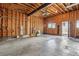 Unfinished two car garage with open stud bay walls and high ceilings at 1401 S Clarkson St, Denver, CO 80210