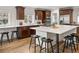 Bright kitchen boasts custom cabinetry, stainless steel appliances, and a large island with seating at 1401 S Clarkson St, Denver, CO 80210