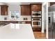 Gourmet kitchen showcasing stainless steel appliances, double ovens, and quartz countertops at 1401 S Clarkson St, Denver, CO 80210