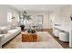 Inviting living room with ample natural light, modern furniture, and hardwood floors at 1401 S Clarkson St, Denver, CO 80210