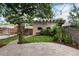 Charming backyard features a stone patio, pergola, a lush lawn area and wooden fencing providing privacy at 1308 York St, Denver, CO 80206