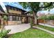 Lush backyard with stone patio, pergola, and lawn, seamlessly blending outdoor living and landscaping at 1308 York St, Denver, CO 80206