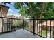 This balcony features iron railings, concrete flooring and a peaceful view of a big tree at 1308 York St, Denver, CO 80206