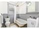 This traditional bathroom is highlighted by a claw foot tub, hexagon floor tile and soft grey trim at 1308 York St, Denver, CO 80206