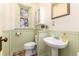 Charming bathroom featuring a decorative stained-glass window and wainscoting detail at 1308 York St, Denver, CO 80206