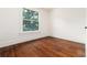 A bedroom with wood flooring, white walls, and a bright window view at 1308 York St, Denver, CO 80206