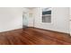 Bedroom with wooden floor and bright windows. Doorway leads to sunroom at 1308 York St, Denver, CO 80206