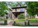 Charming brick home with mature landscaping, a covered front porch, and classic architectural details at 1308 York St, Denver, CO 80206