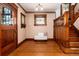 Foyer with hardwood floors, decorative door, stain glass window, bench and staircase at 1308 York St, Denver, CO 80206