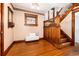 Foyer featuring hardwood floors, decorative door, stain glass window, bench and wood staircase at 1308 York St, Denver, CO 80206