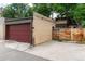 Detached garage with a red garage door and private access to the home's backyard at 1308 York St, Denver, CO 80206