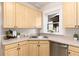 Kitchen with stainless steel appliances, light wood cabinets, and tile floors, corner view at 1308 York St, Denver, CO 80206