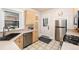 Well-lit kitchen features stainless steel appliances, light wood cabinets and tiled flooring at 1308 York St, Denver, CO 80206