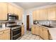 Corner view of the kitchen with stainless appliances and ample cabinet space, bright and welcoming at 1308 York St, Denver, CO 80206
