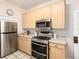 Bright kitchen with stainless steel oven, microwave and refrigerator, and ample cabinet space at 1308 York St, Denver, CO 80206