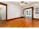 Bright living room with hardwood floors, trim, and french doors to sunroom and powder room at 1308 York St, Denver, CO 80206