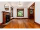 Bright living room with hardwood floors, fireplace, and large windows with decorative trim at 1308 York St, Denver, CO 80206