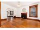 Bright living room with hardwood floors, fireplace, and large windows with decorative trim at 1308 York St, Denver, CO 80206