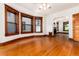 Spacious living room featuring hardwood floors, a bay window, and doorway to other rooms at 1308 York St, Denver, CO 80206
