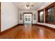 Open living room with hardwood floors, built-in shelves and french doors to sunroom at 1308 York St, Denver, CO 80206