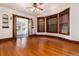 Bright living room featuring hardwood floors, a bay window, and glass paneled french doors at 1308 York St, Denver, CO 80206