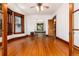 Bright living room with hardwood floors, trim, and doorway to sunroom and other rooms at 1308 York St, Denver, CO 80206