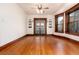Open living room with hardwood floors, built-in shelves and french doors to the exterior at 1308 York St, Denver, CO 80206