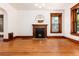 Bright living room with hardwood floors, fireplace, and large windows with decorative trim at 1308 York St, Denver, CO 80206