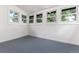 Bright sunroom with blue painted wood floors and white walls and trim at 1308 York St, Denver, CO 80206