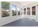 Bright sunroom with multiple windows and painted wood flooring at 1308 York St, Denver, CO 80206