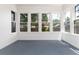 Bright sunroom featuring multiple windows and painted wood flooring at 1308 York St, Denver, CO 80206
