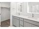 Bathroom with dual vanities, quartz countertops, modern mirrors and a walk-in closet at 2036 S Holly St # 4, Denver, CO 80222