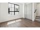 Sun-filled bedroom with a large window, wood-look flooring, and a closet for storage at 2036 S Holly St # 4, Denver, CO 80222