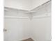 Walk-in closet with ample storage space, rod, shelf, and neutral carpet at 2036 S Holly St # 4, Denver, CO 80222