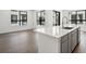 Bright open concept kitchen with island, stainless steel appliances, and wood floors at 2036 S Holly St # 4, Denver, CO 80222